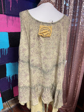 mannequin with a yellowish brown tank  partnered with a real stone and gold necklace with cream beads