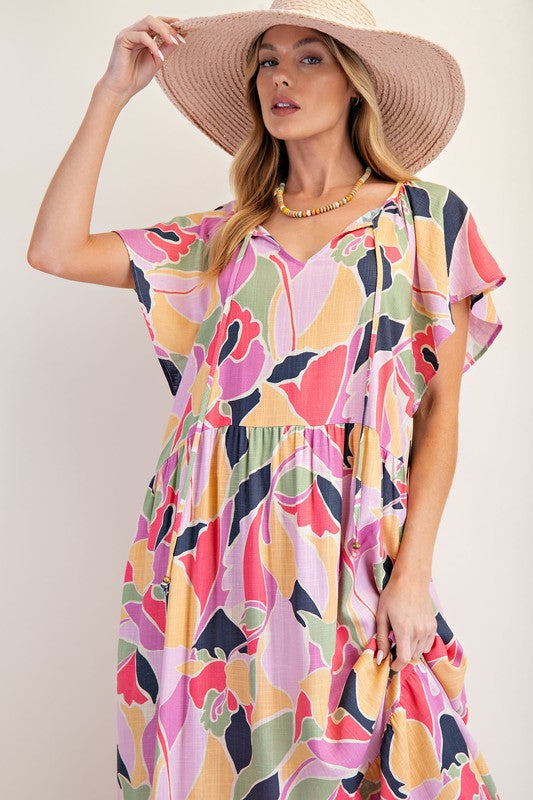 Mutli colored pink background dress
Linen blend woven material
Short winged sleeves with side pockets
Notched neckline with beaded ties
Ruffle bottom detailing
Relaxed loose flowy design
May size down unless you are larger on top. 
Small 3-7, Medium 7-11, Large 12-14