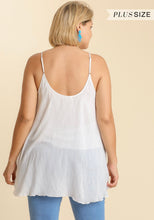 Woman wearing a white layered tank top with 'Plus Size' text above.