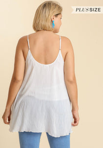 Woman wearing a white layered tank top with 'Plus Size' text above.