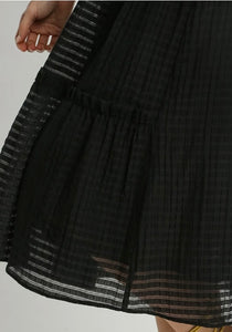 Black textured dress with a white background