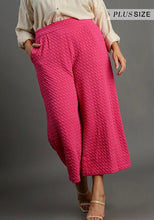 Person wearing pink textured pants on a gray background with 'Plus Size' text.