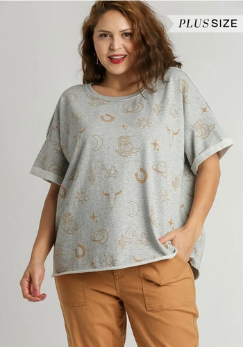 Woman wearing a gray plus size top with star pattern on a plain background