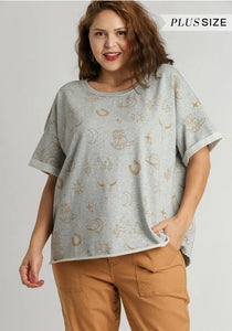 Woman wearing a gray plus size top with star pattern on a plain background