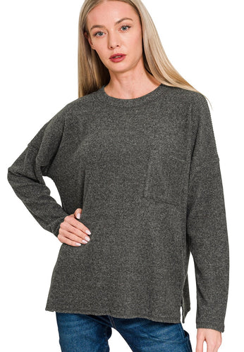 Woman wearing a gray sweater on a white background