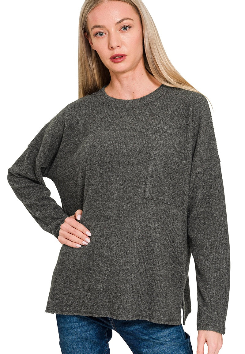 Woman wearing a gray sweater on a white background