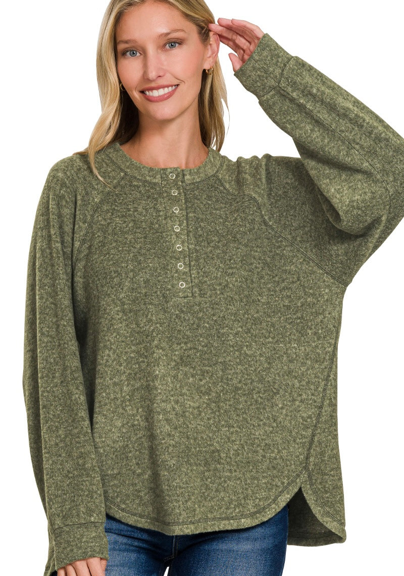 Woman wearing a green long-sleeve shirt with buttons on a white background