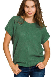Woman wearing a green knitted sweater on a white background