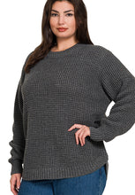 Woman wearing a gray textured sweater on a white background