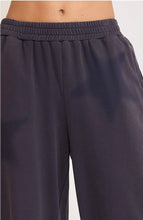 Navy blue pants with a white background