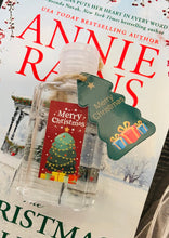 Hand holding an organza bag with clear plastic bottle containing hand sanitizer with a Christmas-themed label