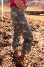 Person wearing patterned jeans standing in a desert landscape